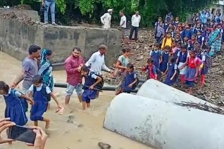 School children cross dangerous drains