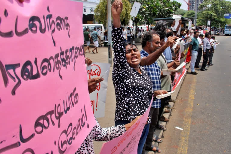Anti-government demonstrators shout slogans during a protest in front of the Fort Railway Station in Colombo on July 27, 2022.
