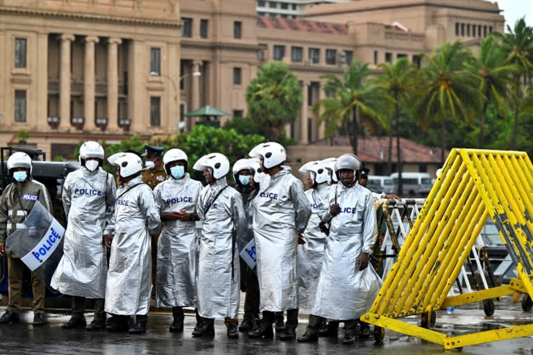 Policemen stand guard during a demonstration by the anti-government protesters near Presidential Secretariat in Colombo on August 3, 2022.