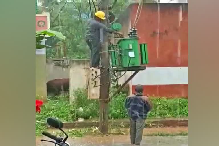 Lineman change transformer in pouring rain