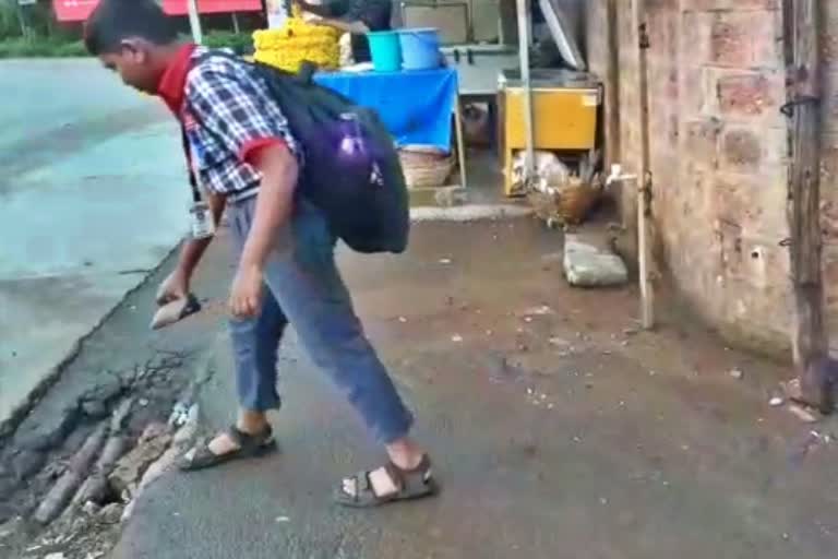 student who covered the road pothole