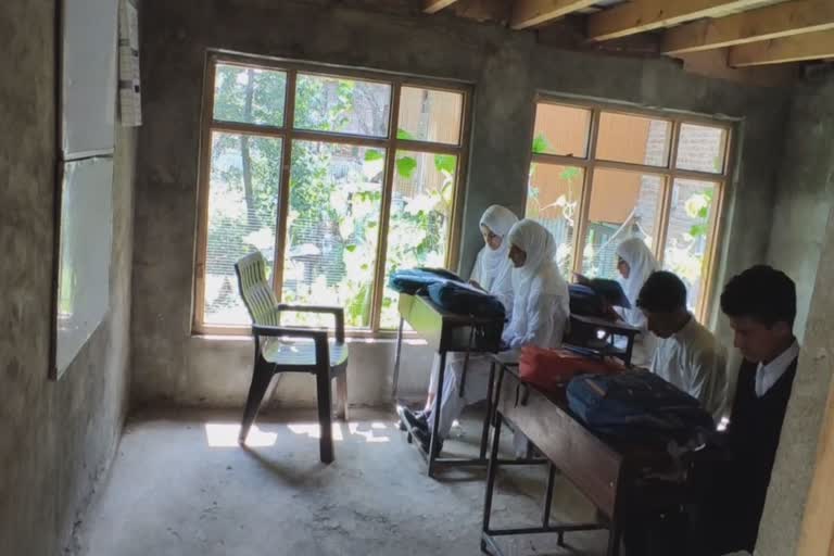 Students read in poultary farm in central Kashmir Budgam