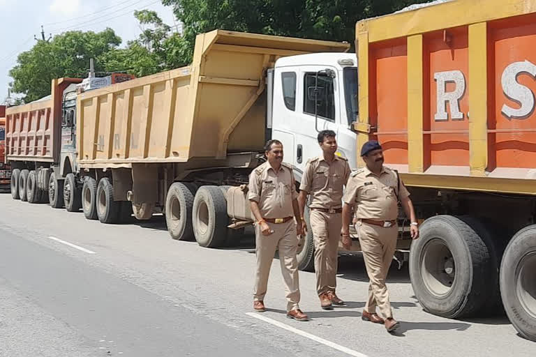 Sand laden trucks waiting for clearance