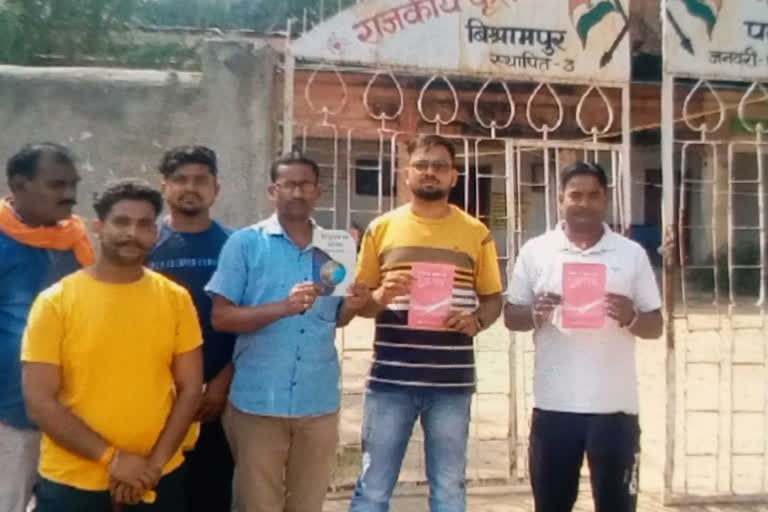 Teacher distributing religious books in Palamu