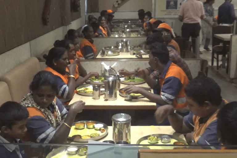 Residents enjoying catering to sanitation workers in a high-end restaurant