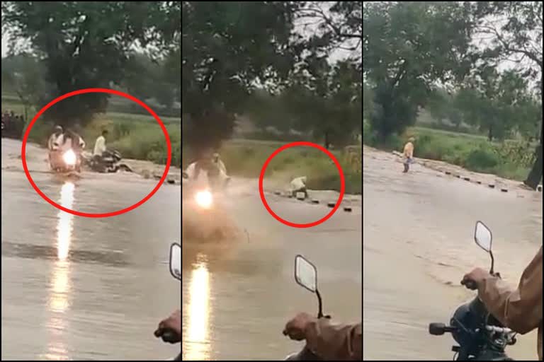 a man washed away with his bike in water