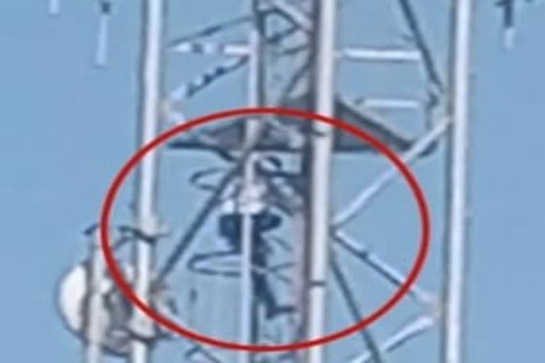 young man climbing the tower