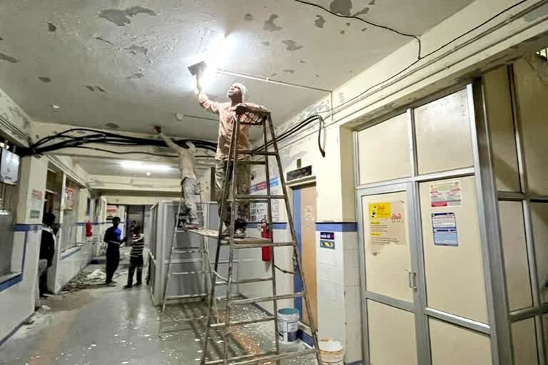 A worker giving fresh coat of paint at Morbi hospital