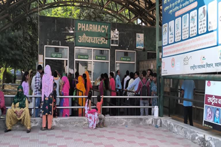 long lines of patients in the hospital for medicines