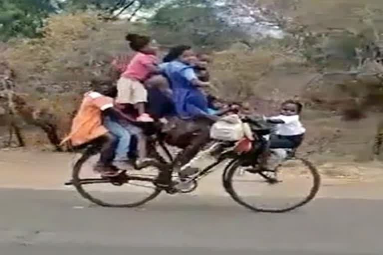 video of a man riding a bicycle with nine children has gone viral