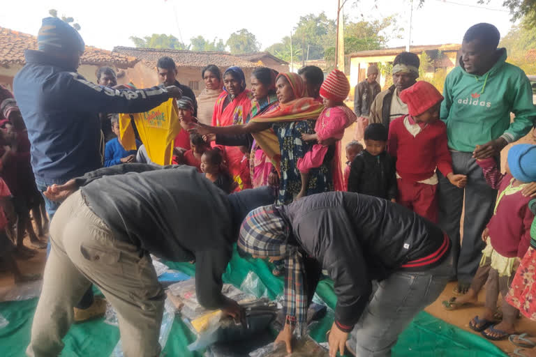 Members distributing clothes among the needy