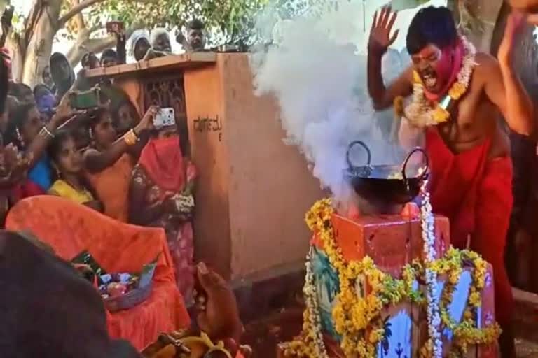 The priest dips his hands in boiling hot oil