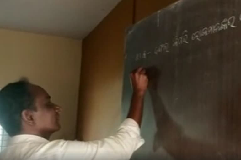 Teacher uses classroom door as blackboard at Jajpur government school