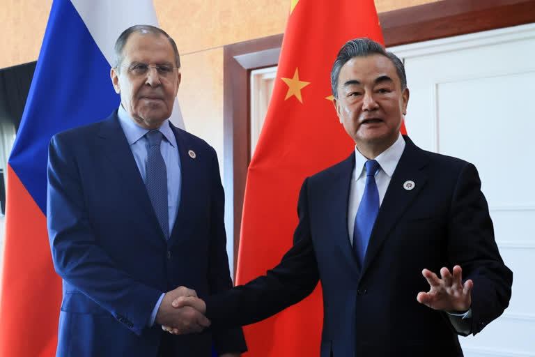 Russian Foreign Minister Sergey Lavrov, left, and Chinese Foreign Minister Wang Yi pose for a photo prior to their talks on the sideline of the 12th East Asia Summit foreign ministers' meeting in Phnom Penh, Cambodia, on Aug. 5, 2022.