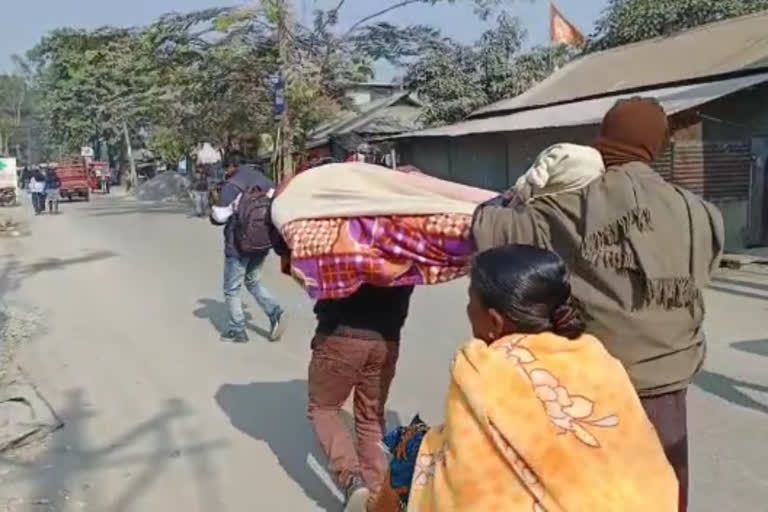 Father-son carries body on shoulders