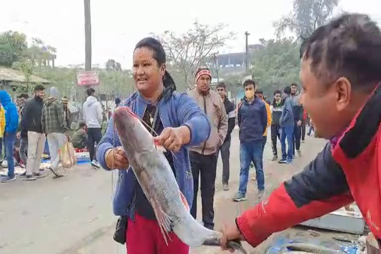 People gather in Nalbari fish market