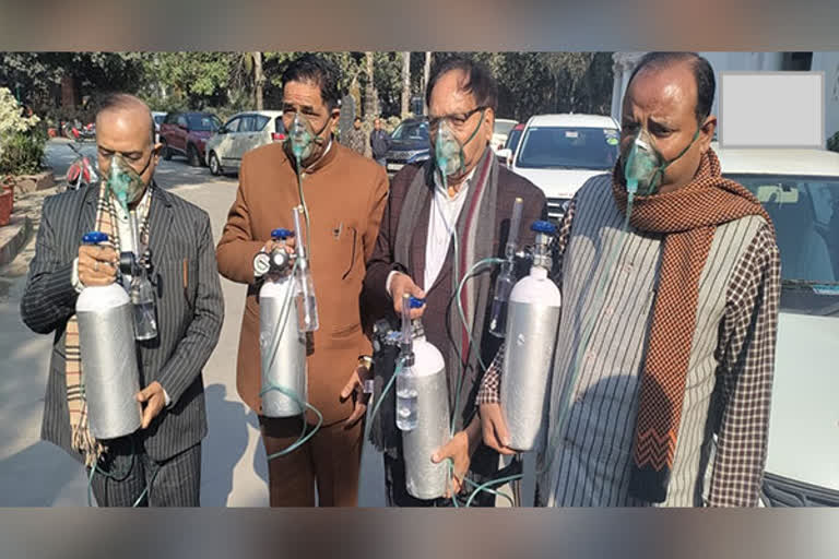 Delhi Assembly BJP MLAs sport oxygen cylinders gas masks