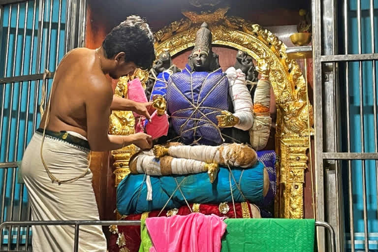 S. Goutham lays the foundation for an elaborate decoration of a deity at the Anantha Padmanabha Swamy Temple in Chennai, India, on Nov. 29, 2022. Goutham is a fifth-generation practitioner of this millennia-old spiritual art of decorating temple deities. (AP Photo/Deepa Bharath)