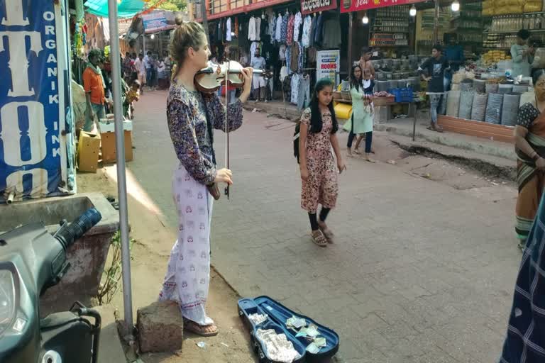 Foreign Female Tourist Playing Violin