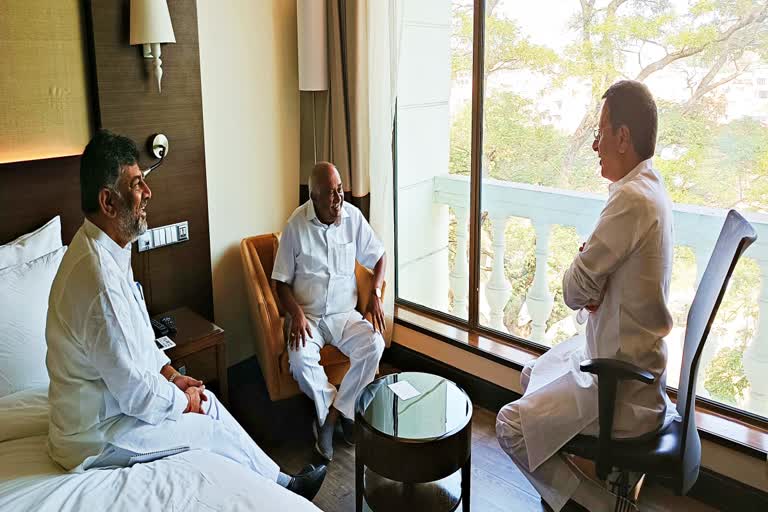 H. Vishwanath, Randeep Surjewala and D. K. Shivakumar talking at a private hotel.
