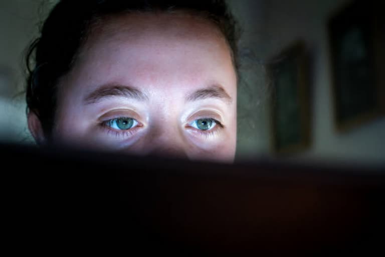 Young woman eyes watching a computer screen