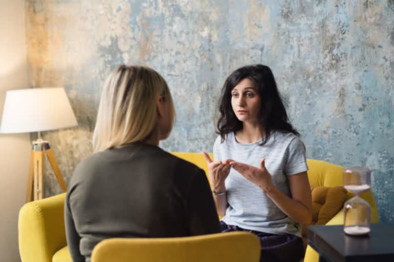 Woman psychologist talking to patient