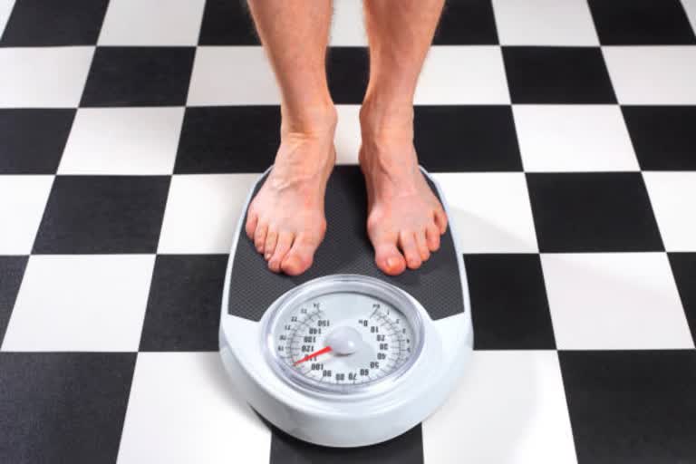 man standing on weight scales