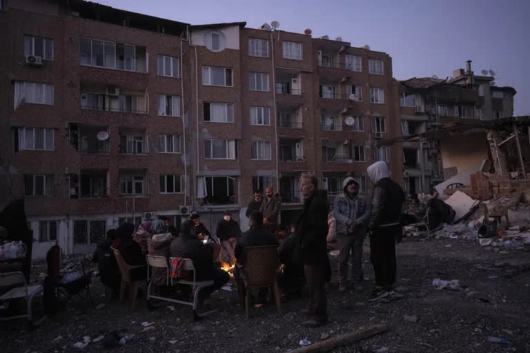 Quake survivors wait amid rubble, to search or say goodbye