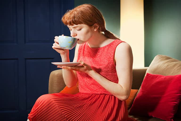 an woman drinking tea