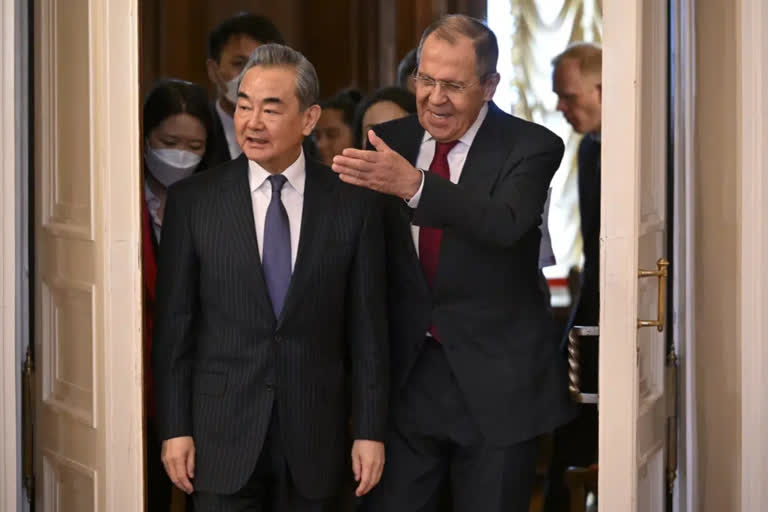 Russian Foreign Minister Sergey Lavrov, right, and the Chinese Communist Party's foreign policy chief Wang Yi