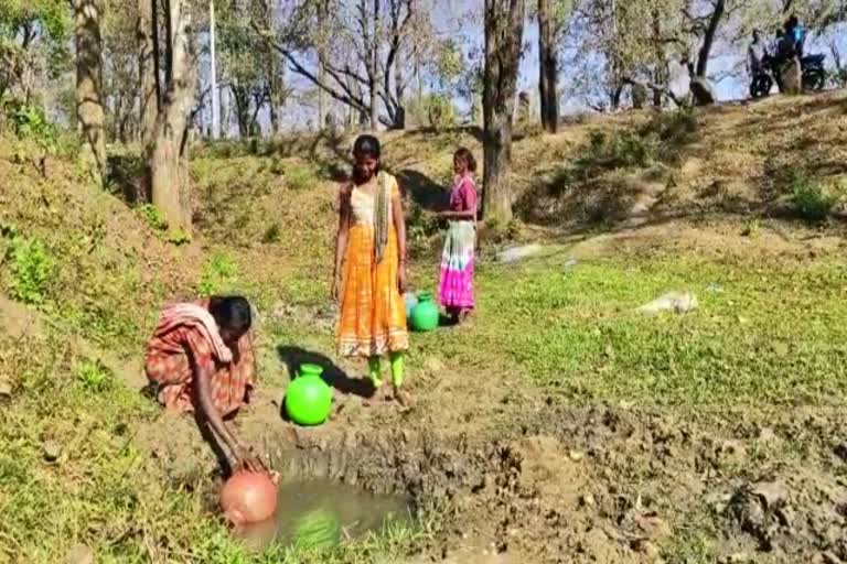 Tribals living by drinking water from the well