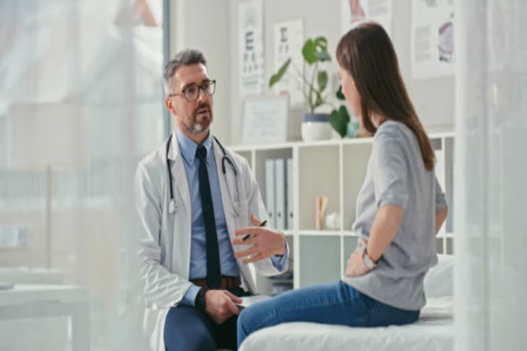 doctor talking with his women patient