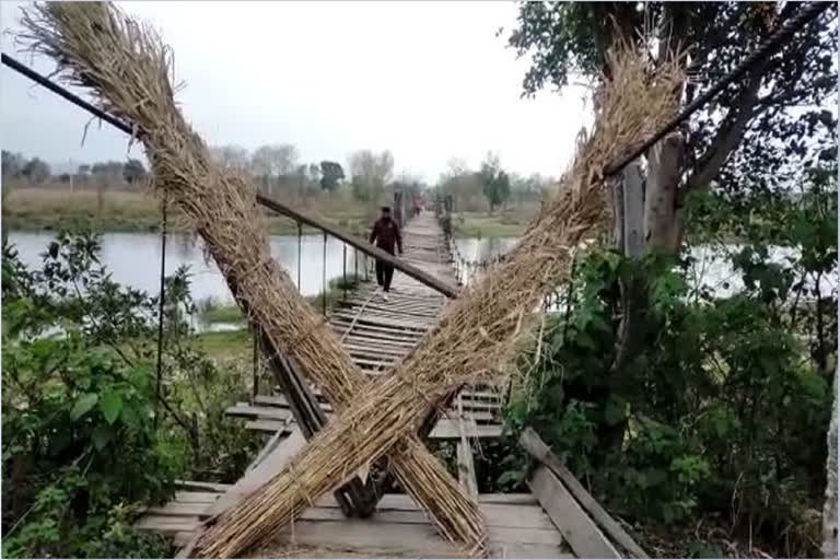 A bridge made of wooden planks and iron ropes connecting Ajauli and Beldhiani villages collapsed
