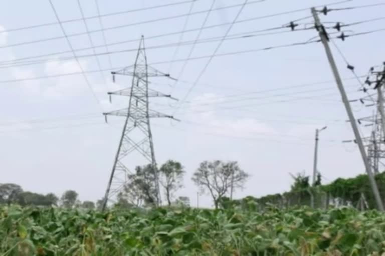 High tension electricity pole in farmers fields