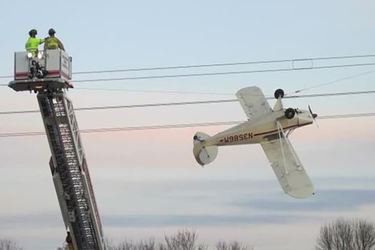 Plane tangled at power lines