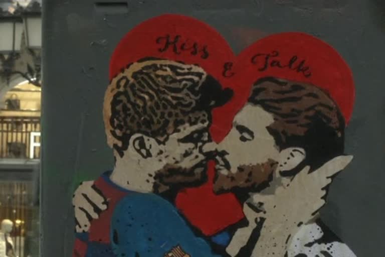 graffiti showing Barcelona and Real Madrid defenders Gerard Pique and Sergio Ramos kissing