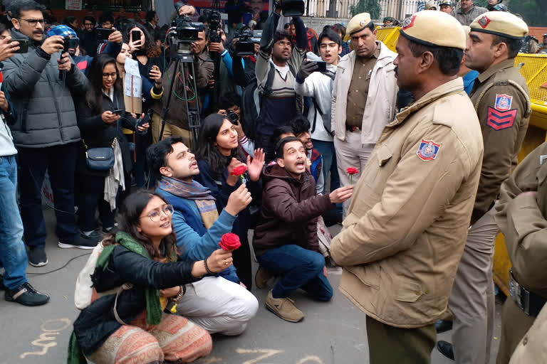 protester present roses to police