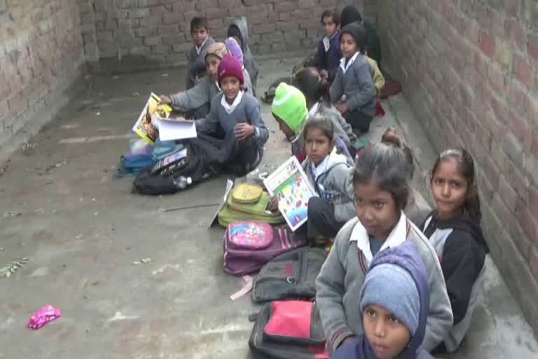 children studying on roof in winter at jind primary school