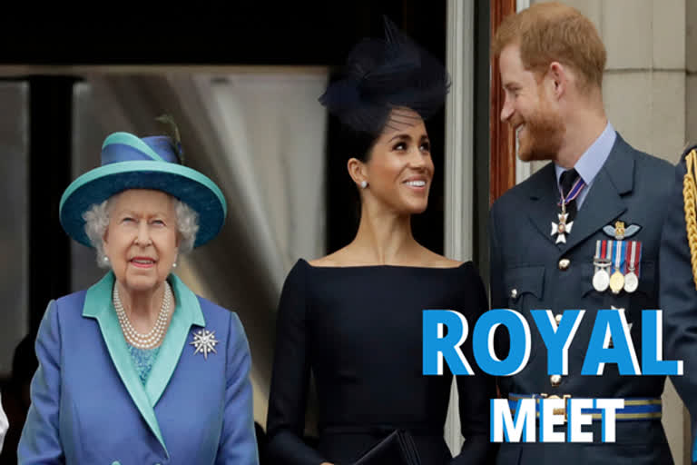 Britain's Queen Elizabeth II, and Meghan the Duchess of Sussex and Prince Harry watch a flypast of Royal Air Force aircraft pass over Buckingham Palace in London.