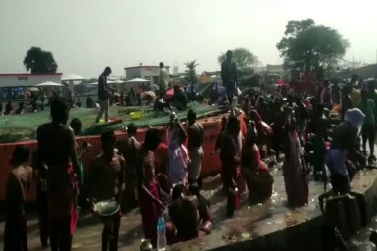 People arrive at waterfall of Pakur on occasion of Makar Sankranti