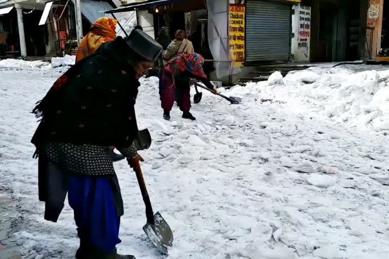 labourers removing snow from roads