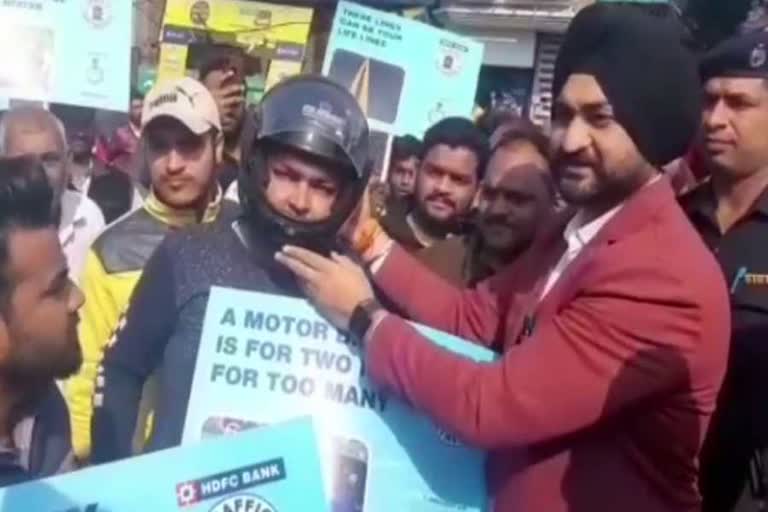 Sandeep Singh has distributed helmets among people