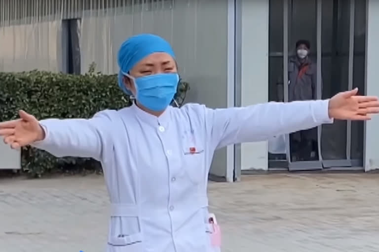 Nurse treating coronavirus patients mimes a hug to her daughter