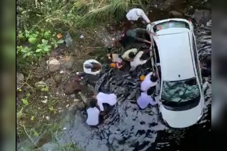 car fell down from bridge in karimnagar