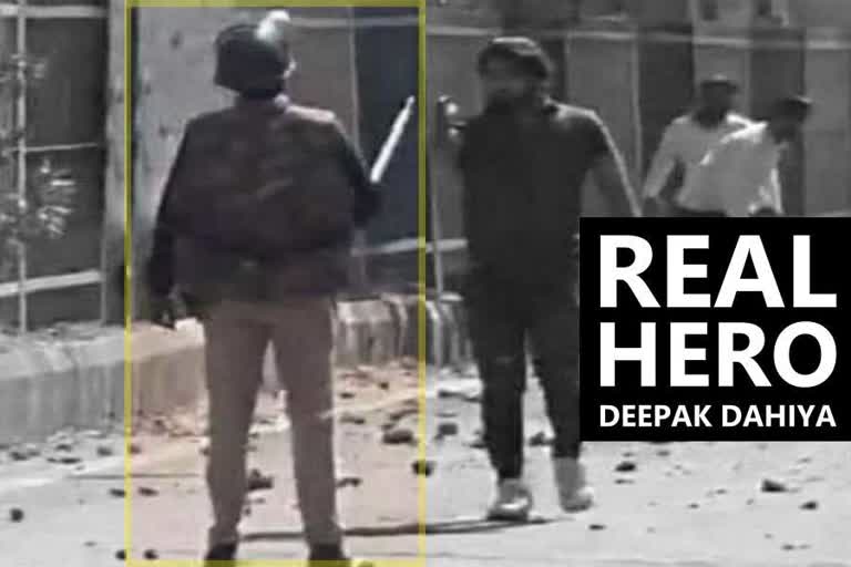 unarmed police constable deepak man seen aiming gun at him in delhi violence