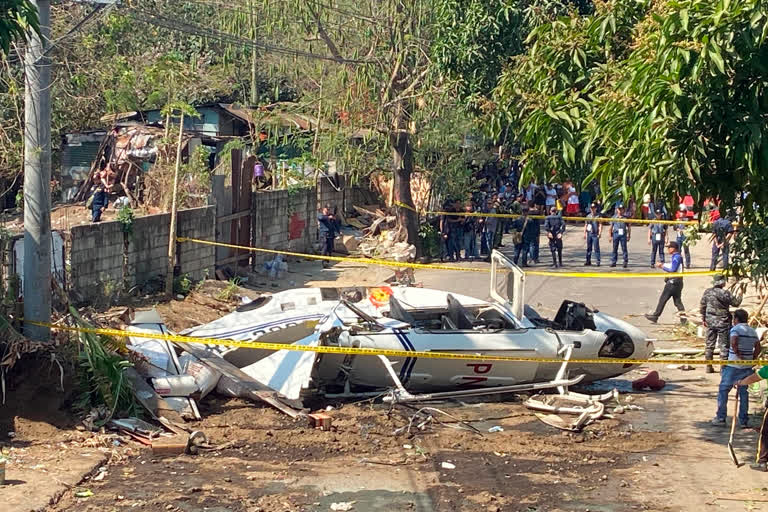 The site of a helicopter crash is cordoned off in San Pedro, Laguna province, south of Manila, Philippines, on Thursday.