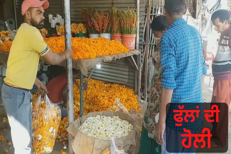 people buying flowers insted of colours on the eve of holi