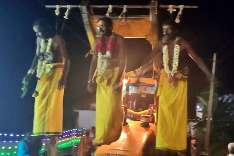 Devotees hanging in the JCB