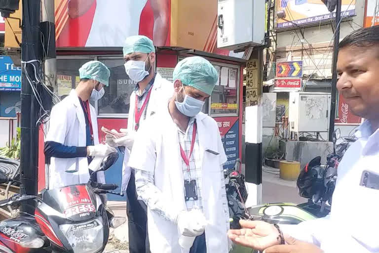 paramedical students sanitizing people on road