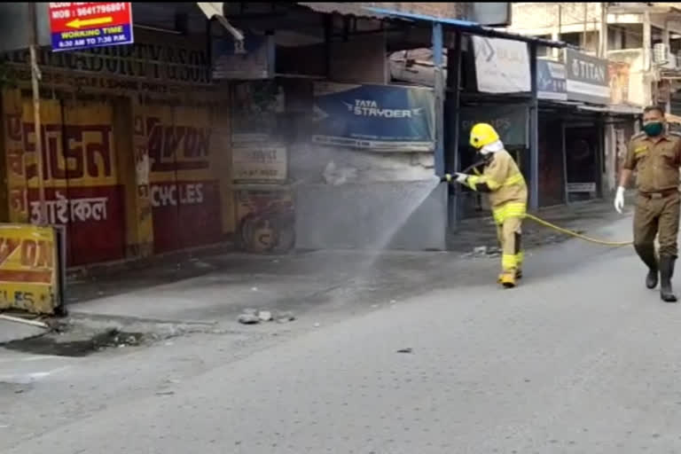 Fire bridgade spraying chemical oil to combat corona in alipurduar, indo-bhutan border